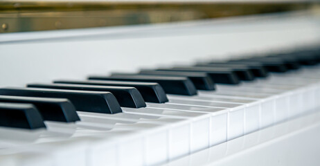 Close-up of white piano keys, musical background.