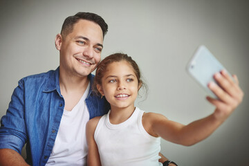 Selfie with dad. Shot of a man taking a selfie with his young daughter.