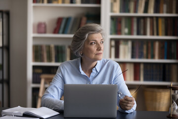 Search solution, brainwork, business vision concept. Serious middle-aged businesswoman sit at...