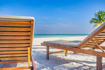 Fototapeta premium Beautiful beach. Couple chairs on the sandy beach near the sea, blurred island landscape exotic shore coast. Summer holiday and dream vacation concept for tourism. Inspirational tropical resort hotel.