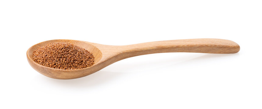 Brown Teff Grain in wood spoon on white