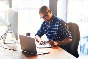 Focused in his creative space. Cropped shot of a young designer working in the office.