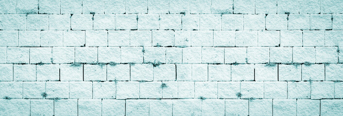Obraz premium Abstract teal brick wall texture light turquoise old stucco and vintage brickwork pattern background in home interior, grunge rusty blocks of stonework green mint color wide wallpaper bacground.
