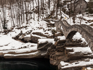 Winter scenery in Verzasca Valley, canton Ticino, Switzerland at the bridge Ponte Romano, Ponte dei Salti
