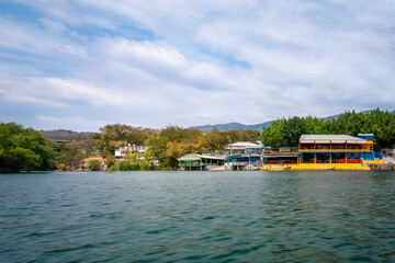 View of Tuxtla Gutierrez City port from the water on a boat tour of Sumidero Canyon, Chiapas, Yucatan, Mexico. Sumidero Canyon, a deep natural canyon and a popular tourist destination in south Mexico.