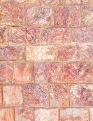 reddish brown stone wall closeup, seamless pattern background