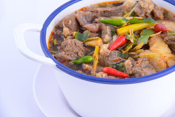 Thai favorite food. Spicy chicken soup (Tom Yum Gai Baan) in the white bowl.