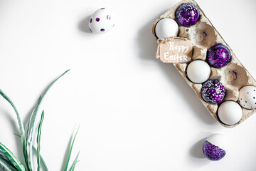 Easter background with decorative eggs tray isolated on white, flat lay.