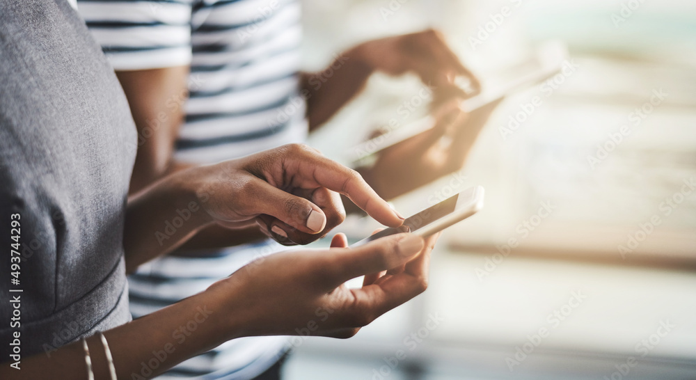 Aufkleber staying in the loop. closeup shot of businesspeople using their digital devices in an office.