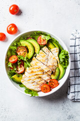Grilled chicken breast salad with avocado and cherry tomatoes. Healthy diet food concept.