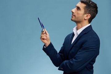 successful man looking up with a blue notepad emotions business and office concept