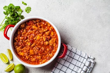 Fotobehang Vegan chili con carne with vegetables and beans in tomato sauce in a red saucepan. Mexican food concept. © vaaseenaa