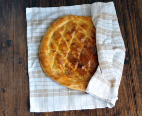 Freshly baked fragrant homemade bread flatbread on the table under the morning sun