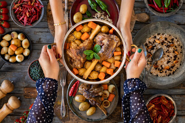 A plate of grilled lamb with pilau with spice, small plates, carrots.