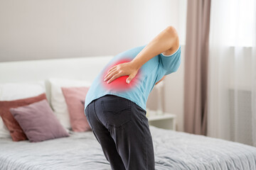 Back pain, kidney inflammation, man suffering from backache at home