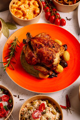 close-up of roasted chicken with baked potatoes