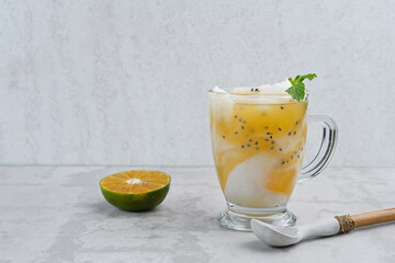 Es Kelapa Jeruk, a typical Indonesian drink made from fresh oranges squeezed with grated young coconut.

