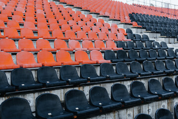 Naklejka premium Empty stands and seats for fans and fans in the open-air stadium. Lack of fans during the pandemic.