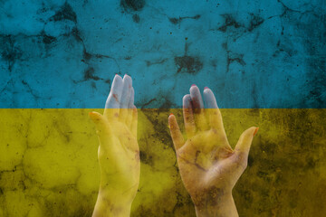 Hands in prayer. Prayer for Ukraine. Ukrainian flag. Prayer for the whole world
