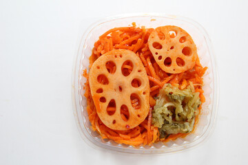 Salad Lotus with carrots and lotus. Salad in a disposable bowl.