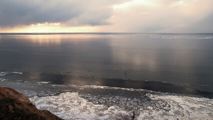 The drone flies over canyons and a frozen river or sea. Photo from a bird's eye view. View from above.