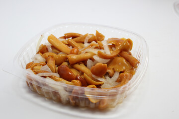 Honey mushrooms marinated with onions . Lunch in a disposable dish.