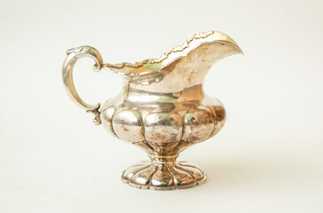 Antique silver jug on white background