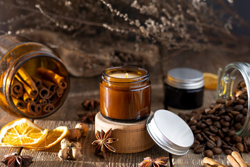 A set of different aroma candles in brown glass jars. Scented handmade candle. Soy candles are burning in a jar. Aromatherapy and relax in spa and home.