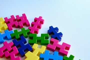 Colored puzzles on a light background. Logic games constructor for children and adults. Bright background and texture
