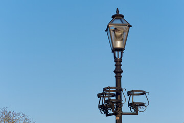 Close-up shot of a vintage street lamp with a sky in the background