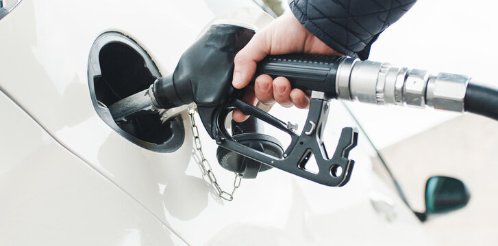 Hand puts fuel pump into car