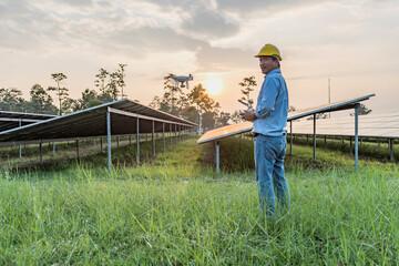 Engineers or workers People use drones to explore solar panels or solar cells on the roof of a farm. power plant with green fields renewable energy Eco-technology concept for electric power