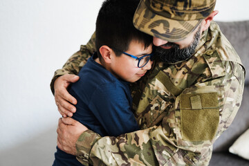 Soldier greeting and hugging his son at home - Focus on kid face