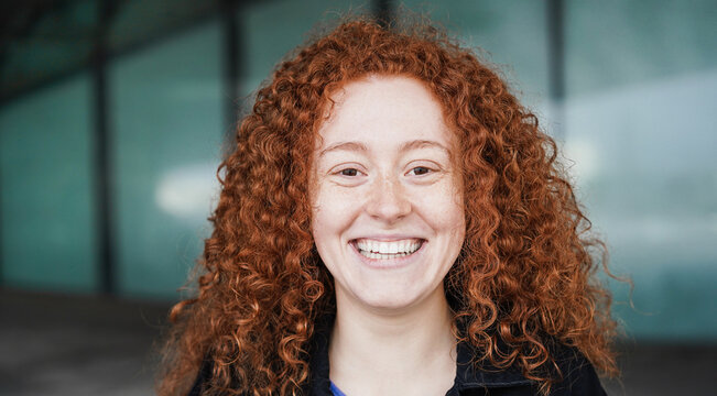 Happy readhead girl smiling on camera outdoor - Focus on face