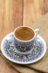 Turkish coffee on wood floor. Classic Turkish coffee cup on cloth.