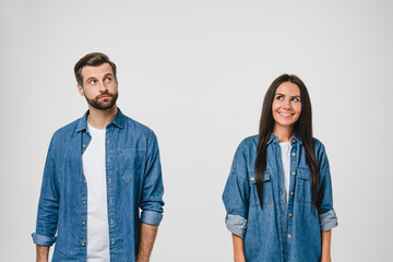 Thoughtful pensive caucasian young couple spouses boyfriend and girlfriend looking upwards for...