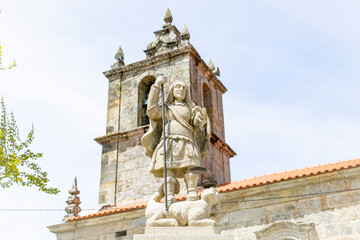 statue of Saint Michael the Archangel in front of the church at Mezio village, Castro Daire, district of Viseu, Portugal - obrazy, fototapety, plakaty