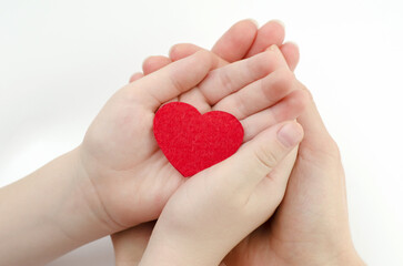 Mother and son hands holding red heart isolated on white background, heart health insurance, family day, world heart day