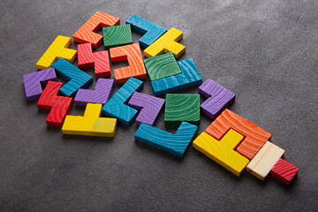 Creative idea and solve the problem concept. Teamwork success strategy - wooden jigsaw on the grey background