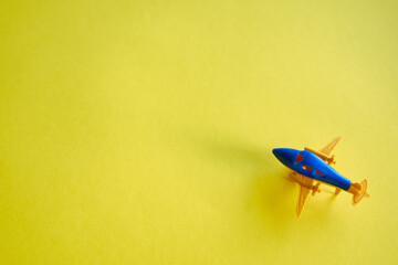 Yellow-blue toy plane on a yellow background. Takeoff!
Travel concept. Place for text and advertising