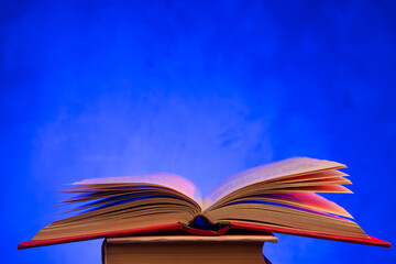 Open book on the table. Education and reading concept. Retro neon light