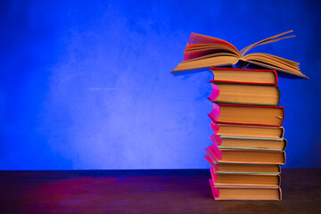 Wisdom and education concept.Book on the table, love reading. Retro neon light 90s