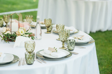 Wedding. Banquet. The chairs and round table for guests, served with cutlery.
