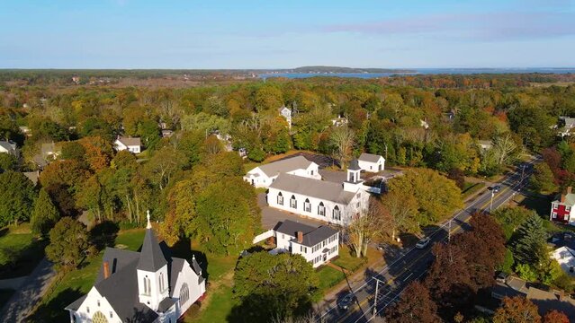 Kingston historic town center including Mayflower Congregational Church, Restoration Community Church and First Unitarian Church on Main Street aerial view with fall foliage, Massachusetts MA, USA.