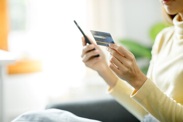 Online payment or online shopping, Woman's hands holding smartphone and using credit card for online shopping and Online payment at home.