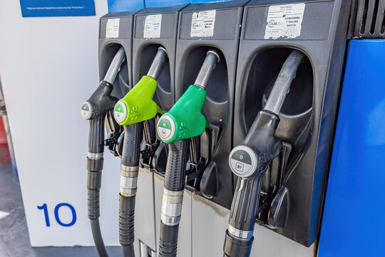 Huelva, Spain - March 19, 2022: Pump nozzles of a petrol pump in service station