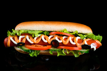 Delicious freshly cooked hot dogs with sausages, vegetables, cheese and sauce