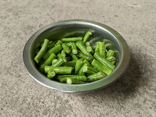Slices of yardlong bean vegetables in a metal container