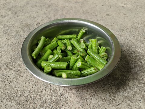 Slices of yardlong bean vegetables in a metal container