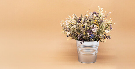 Beautiful dried flowers bouquet in vase against light background. Still life of withered flowers bouquet.
